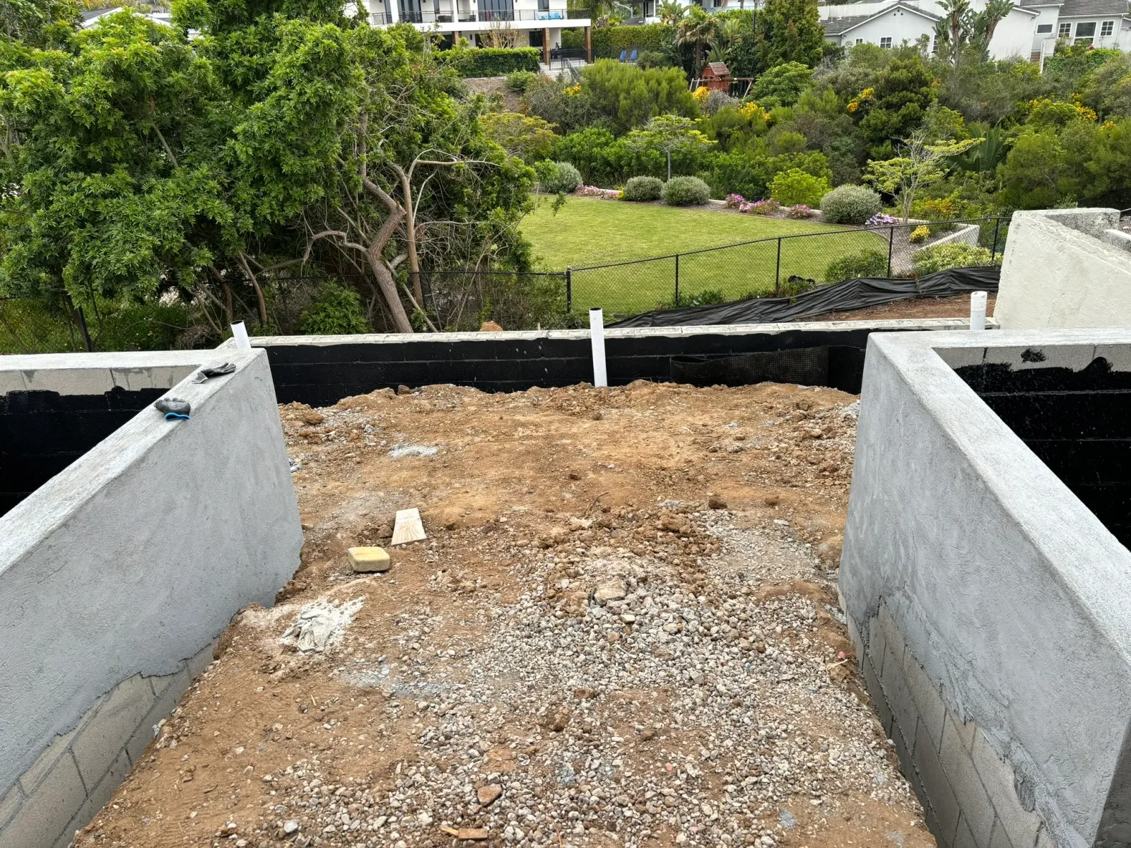 Coastal Carlsbad backyard with paver patio, patio cover, and ocean-tolerant planting