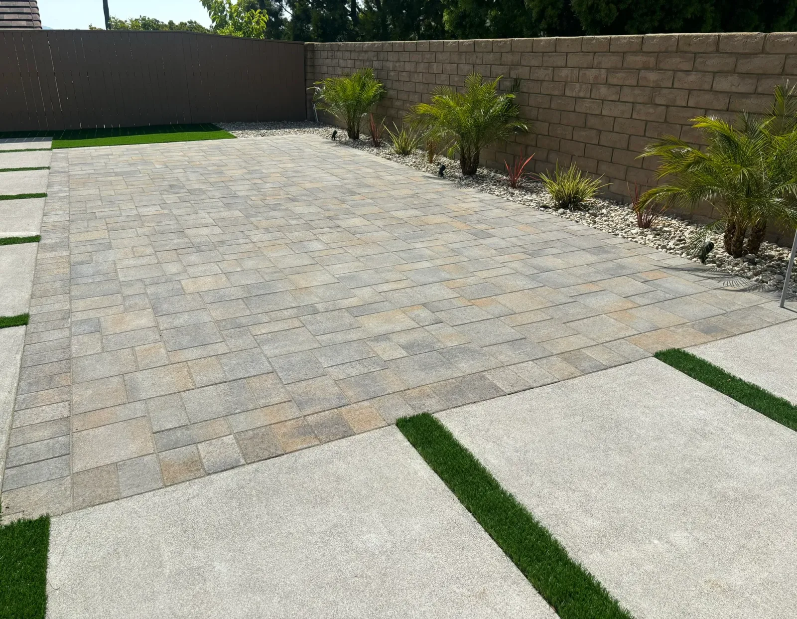 Multi-zone backyard remodel in Escondido with pool deck, patio, fire feature, and drought-tolerant planting