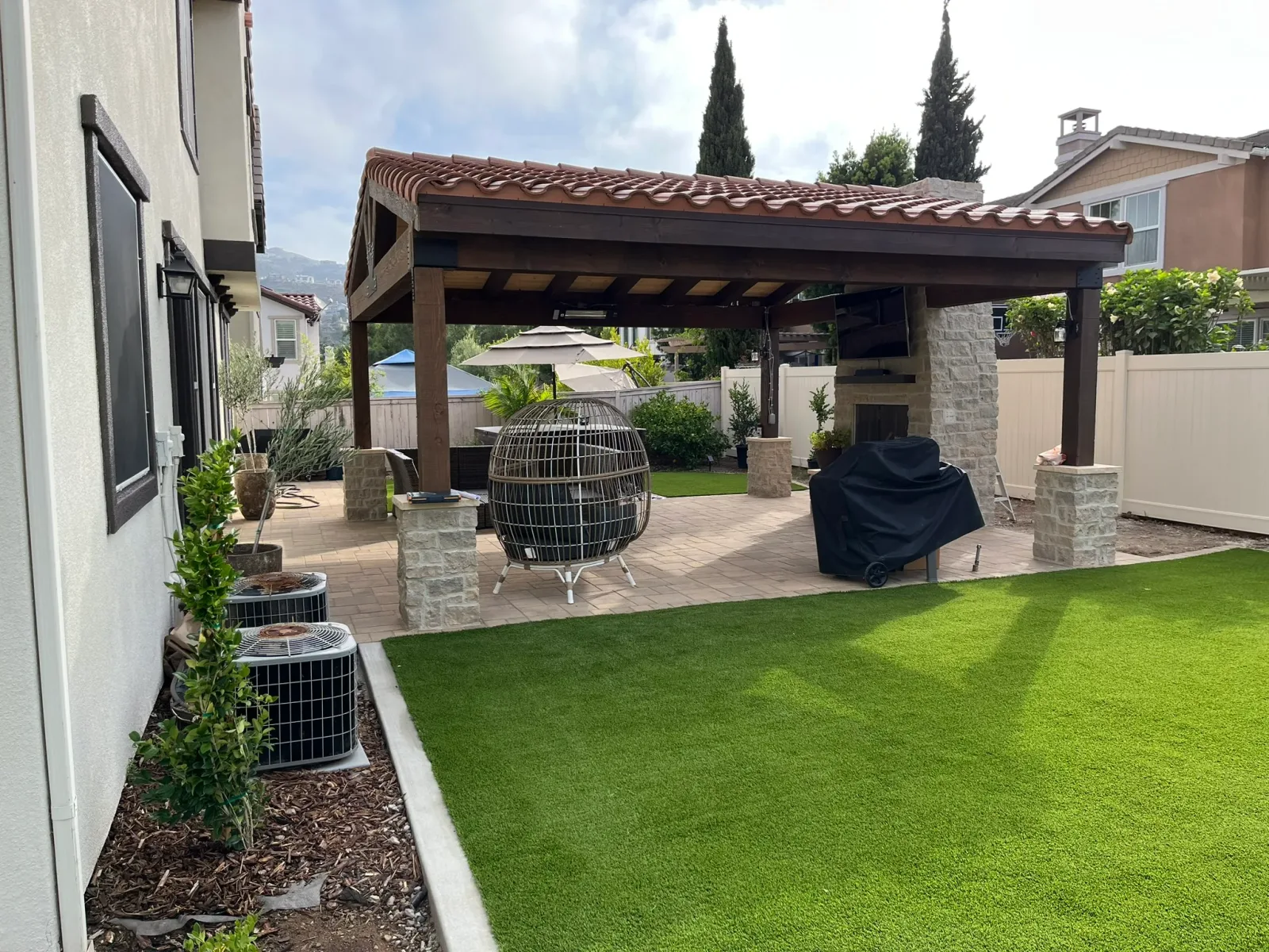 Complete backyard build in San Marcos with terraced walls, paver patio, outdoor kitchen, and lawn